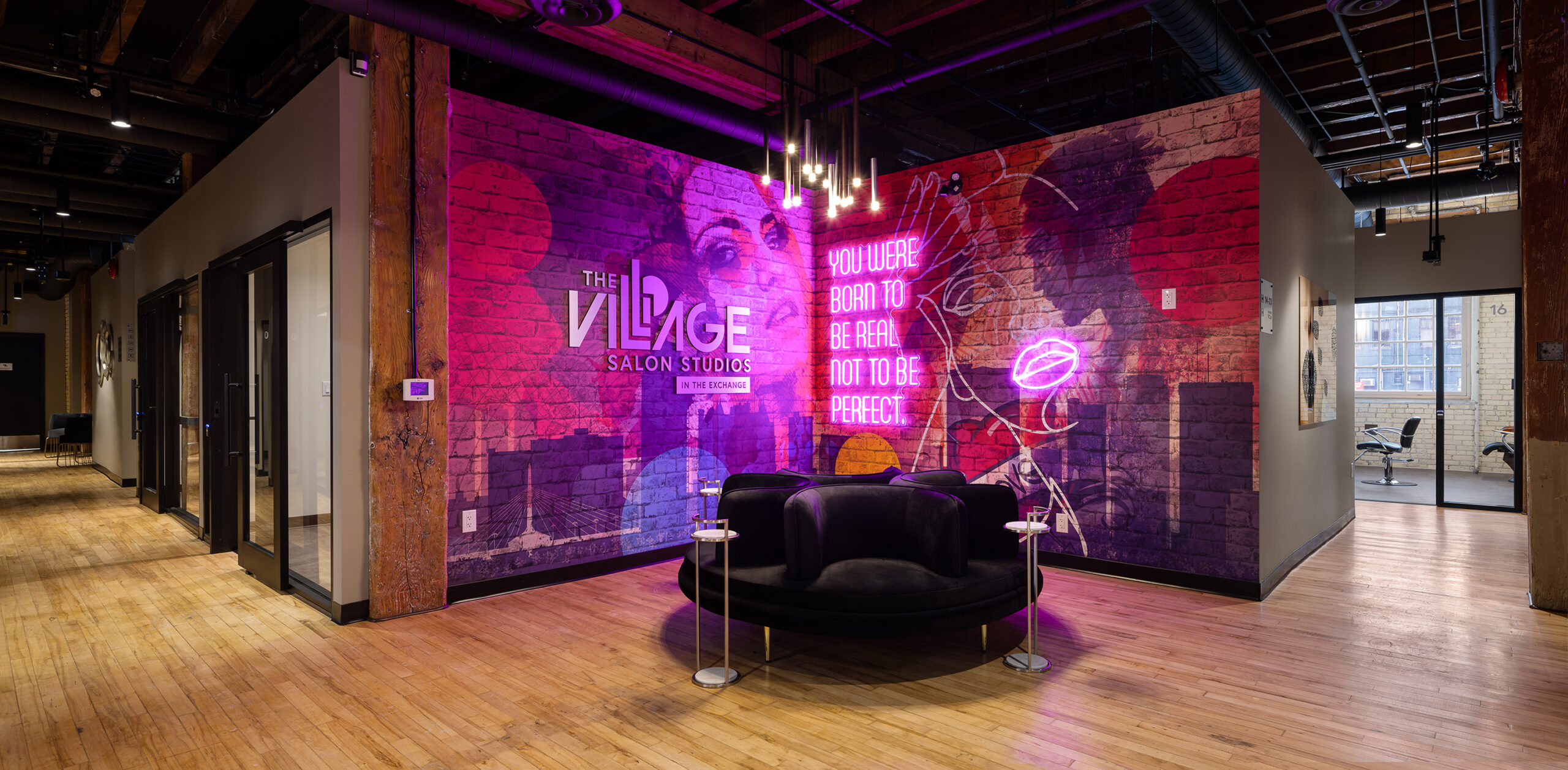 Main entrance decorated with Village logo, mural, nice seating and lights.